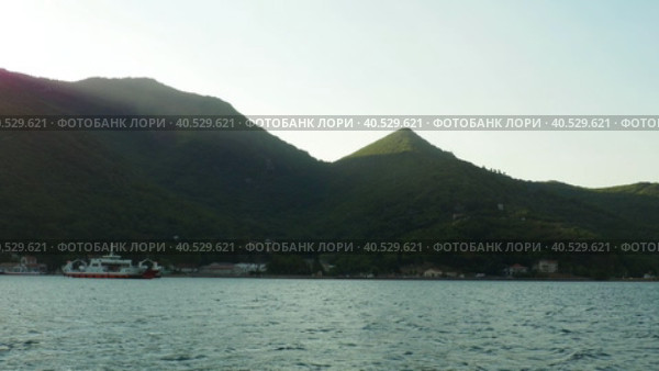 Boka Kotor Adriatic Sea, Verige Strait Lepetane Ferry Line Trajekt. People, cars and houses on the shore in the evening. Tourism and business in Montenegro. Maritime transport ferryboat August 18 2022. Стоковое видео, видеограф Юлия Петровская / Фотобанк Лори
