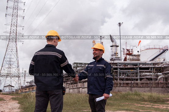 Both of Petroleum engineer is on a mission to inspect oil distillation at a huge oil refinery. Стоковое фото, агентство Ingram Publishing / Фотобанк Лори