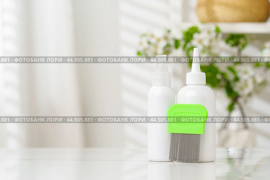 Bottles of Lice Treatment Products and a Comb on a Countertop. Стоковое фото, фотограф Сергей Толмачёв / Фотобанк Лори