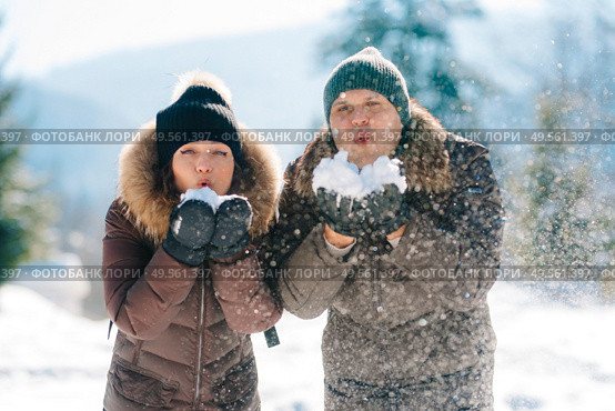 boy and girl outdoors on a winter walk playing snowballs and sledding. Стоковое фото, агентство Ingram Publishing / Фотобанк Лори