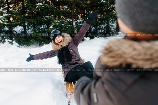 boy and girl outdoors on a winter walk playing snowballs and sledding. Стоковое фото, агентство Ingram Publishing / Фотобанк Лори
