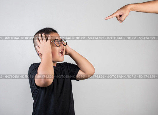 Boy feels sad after the parents scold him. Стоковое фото, агентство Ingram Publishing / Фотобанк Лори