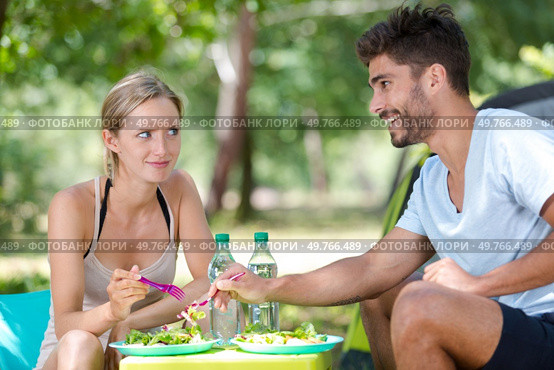 boyfriend taking salad from partners plate. Стоковое фото, агентство Ingram Publishing / Фотобанк Лори