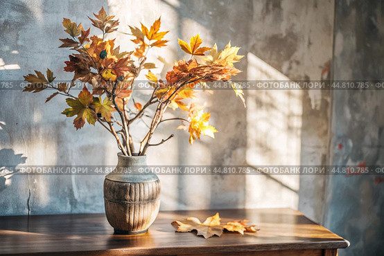 Branches with golden autumn leaves in a ceramic vase on a wooden table by the window. The concept of home comfort. Autumn decor for Halloween. Стоковое AI-изображение, AI-художник Photojuli / Фотобанк Лори