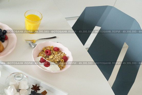 Breakfast with orange juice, porrige and coffee on dinner white table. Breakfast with cereles. Стоковое фото, агентство Ingram Publishing / Фотобанк Лори