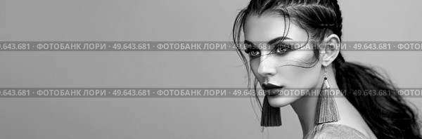 Brunette girl with perfect makeup. Beautiful model woman with curly hairstyle. Care and beauty hair products. Lady with braided hair. Model with jewelry. Black and White photo. Стоковое фото, агентство Ingram Publishing / Фотобанк Лори