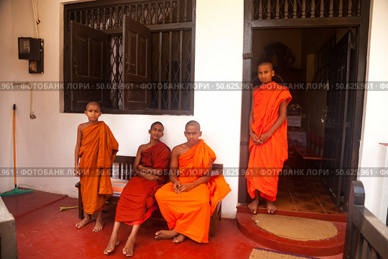 Buddhist Monks in Traditional Attire at a Temple in Sri Lanka Enjoying the Outdoors. Редакционное фото, фотограф Aleksandr Golubev / Фотобанк Лори