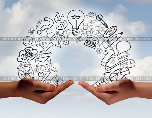 Business exchange concept as two human hands from diverse cultural backgrounds exchanging financial and economic information and training as a metaphor for team success. Стоковое фото, агентство Ingram Publishing / Фотобанк Лори