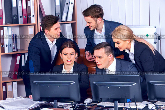 Business people team people working with papers by computer monitor. Стоковое фото, фотограф Gennadiy Poznyakov / Фотобанк Лори