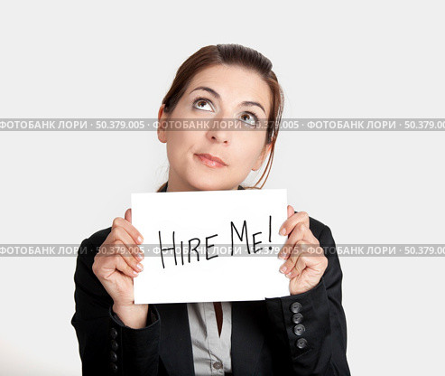 Business woman holding a card board with the text message "Hire me" Стоковое фото, агентство Ingram Publishing / Фотобанк Лори