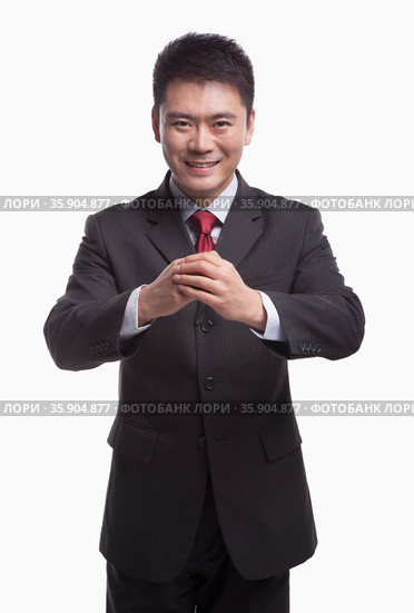 Businessman Bowing Toward Camera. Стоковое фото, агентство Ingram Publishing / Фотобанк Лори
