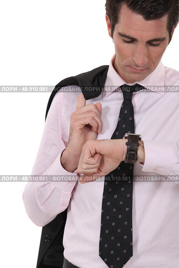 Businessman checking his watch for the time. Стоковое фото, агентство Ingram Publishing / Фотобанк Лори