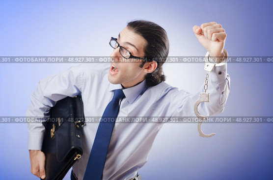 Businessman handcuffed for his crimes. Стоковое фото, агентство Ingram Publishing / Фотобанк Лори