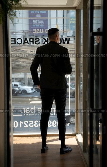 Businessman in the corridor in the conference room Relax with various posture before presenting work and new projects to the management team for consideration in the meeting room. Стоковое фото, агентство Ingram Publishing / Фотобанк Лори