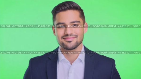 Businessman smiling confident on green screen. Male dressed in a stylish formal outfit. Professional millennial man isolated on green background. Chroma key backdrop. Headshot portrait. Presentation. Стоковое AI-видео, аниматор Марина Демидюк / Фотобанк Лори