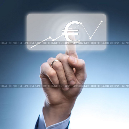 Businessman touched euro currency icon on virtual financial screen.A graph indicating growth.Finance and technology concept.. Businessman touched euro currency icon. Стоковое фото, агентство Ingram Publishing / Фотобанк Лори