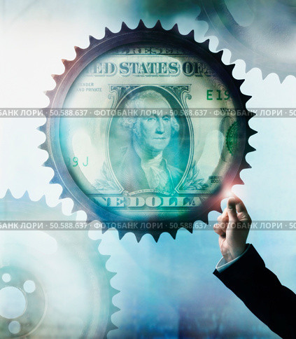 Businessman touching cog wheel with US Dollar in center. 24316769. Стоковое фото, агентство Ingram Publishing / Фотобанк Лори
