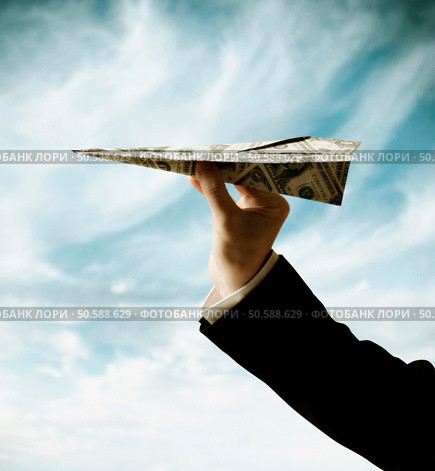Businessman’s hand holding airplane made of US Dollars. 24316760. Стоковое фото, агентство Ingram Publishing / Фотобанк Лори