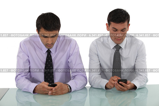 Businessmen sending text messages. Стоковое фото, фотограф Phovoir Images / Фотобанк Лори