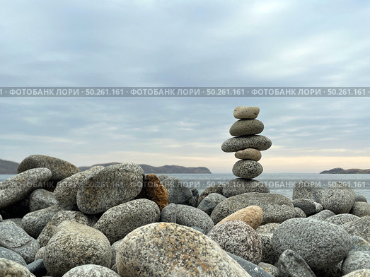 Cairn of smooth stones on the seashore. Harmony, meditation, contemplation. Стоковое фото, фотограф Кирилл Зотов / Фотобанк Лори