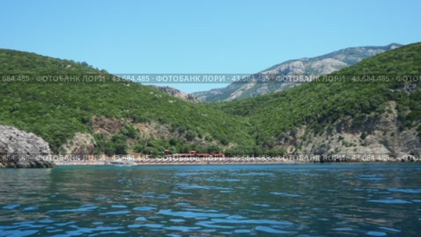 Canj Montenegro 07.22.24 Flysch marine sedimentary rocks lithological layers. Adriatic sea. Pecin bay halfway between Petrovac and Sutomore. The Queen Beach. Hills and inaccessible rocks. Kraljicina (2024 год). Редакционное видео, видеограф Юлия Петровская / Фотобанк Лори