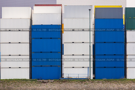 Cargo Containers Goods Stack at the Pier docks port waiting for international sea freight transportation in Rotterdam Port of Netherlands. Стоковое фото, агентство Ingram Publishing / Фотобанк Лори