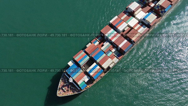 Cargo ship filled with containers in port area. Стоковое фото, фотограф Михаил Коханчиков / Фотобанк Лори