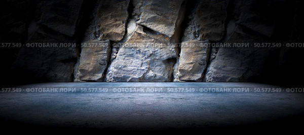 Cement floor and rock wall background and spotlight. Concrete and rock floor background. Стоковое фото, агентство Ingram Publishing / Фотобанк Лори