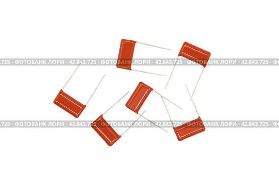 Ceramic electronic capacitors for soldering to a printed circuit board are isolated on a white background. Стоковое фото, фотограф Сергей Н / Фотобанк Лори
