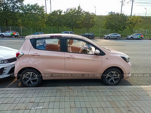 Changan BenBen E-Star is a 5-door city car hatchback. Pink small Changan Benni. Редакционное фото, фотограф Константин Григорьев / Фотобанк Лори