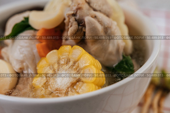 Chicken soup with corn, shiitake mushroom, enoki mushroom, and carrot. Стоковое фото, агентство Ingram Publishing / Фотобанк Лори