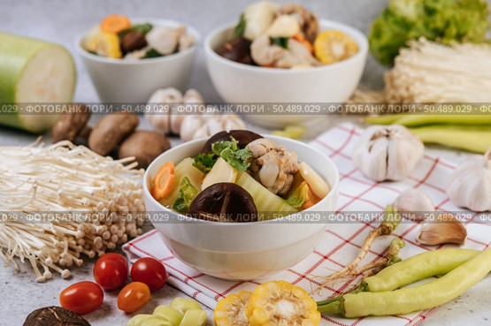 Chicken soup with corn, shiitake mushroom, enoki mushroom, and carrot. Стоковое фото, агентство Ingram Publishing / Фотобанк Лори