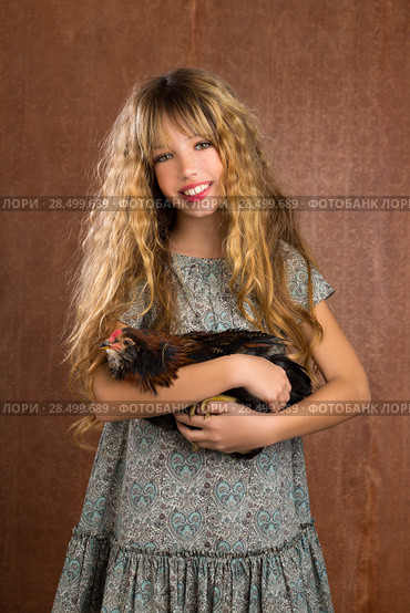 Children fashion farmer girl holding hen in retro vintage background. Стоковое фото, фотограф Tono Balaguer / Ingram Publishing / Фотобанк Лори