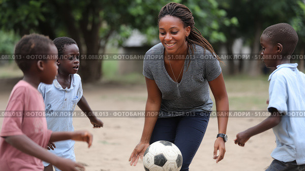 Children play football with a teacher in an African school, in the backyard. Black African children from disadvantaged families study in school, read books, receive primary education, volunteer service. Стоковое AI-изображение, AI-художник ALLA YURTAYEVA / Фотобанк Лори