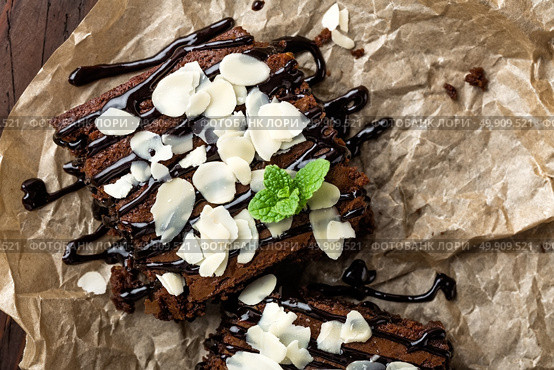 Chocolate brownie cake, dessert with nuts on dark background, directly above, flat lay. Стоковое фото, агентство Ingram Publishing / Фотобанк Лори