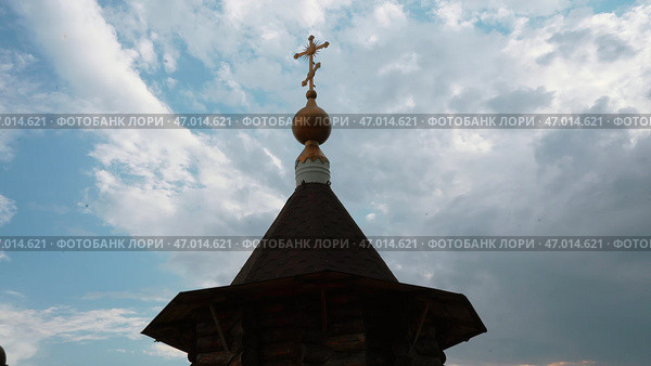 Christian orthodox church building with cross on roof top under cloudy sky low angle shot. Стоковое фото, фотограф David Kashakhi / Фотобанк Лори