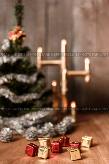 Christmas decorative tree is adorned with rain stands on the table with a lit lamp lights. Стоковое фото, агентство Ingram Publishing / Фотобанк Лори
