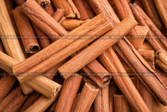 Cinnamon background. Pile of cinnamons stick top view. Cinnamomum cassia close up. Spice for the Holidays. Assortment of spices. Cinnamon bark is a spice used for sweet and savory dish. Стоковое AI-изображение, AI-художник Марина Демидюк / Фотобанк Лори