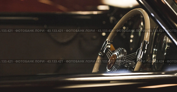 Classic luxury interior of a retro Alfa Romeo car and a close-up steering wheel. Russia, May 11, 2024. Редакционное фото, фотограф Photojuli / Фотобанк Лори