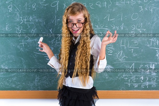 Clever nerd pupil blond girl in green board student happy schoolgirl. Стоковое фото, агентство Ingram Publishing / Фотобанк Лори