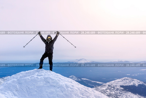 Climber exults reaching the top of the mountain peak. Стоковое фото, фотограф Евгений Харитонов / Фотобанк Лори