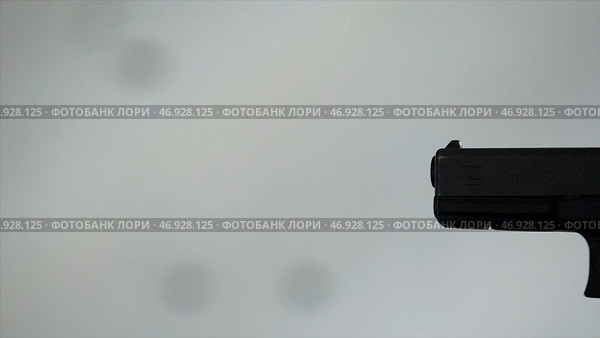 Close profile of man holding a 9 mm handgun, then takes a shot. Стоковое фото, фотограф David Kashakhi / Фотобанк Лори