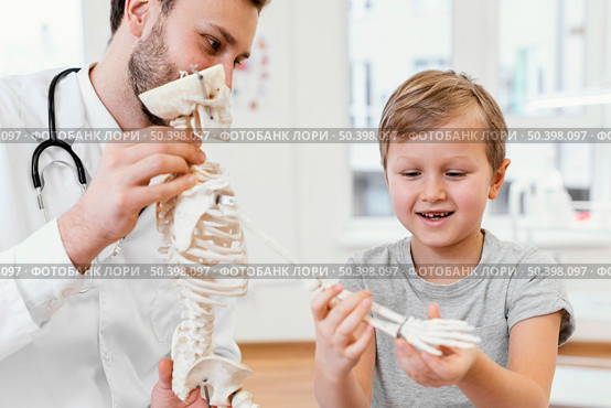 close up doctor kid with skeleton. Стоковое фото, агентство Ingram Publishing / Фотобанк Лори