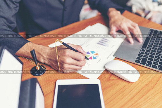 Close up hands signing terms of agreement documents of businessman on his desk, business signing concept. Стоковое фото, агентство Ingram Publishing / Фотобанк Лори