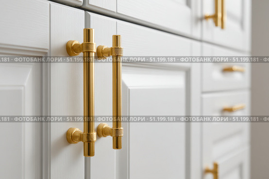 Close-up macro of golden cabinet hardware on white doors. Handle with brass finish. Minimalist simple interior style. Cabinet door double doors with both handles. Furniture base set design. Стоковое AI-изображение, AI-художник Марина Демидюк / Фотобанк Лори