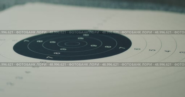 Close-up of a shooting range target sheet for practice and accuracy. Стоковое видео, видеограф Igor Tichonow / Фотобанк Лори