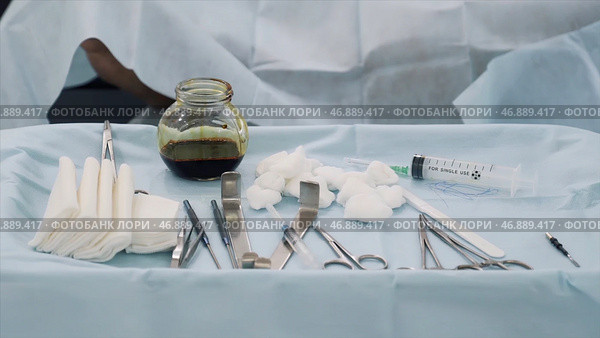 Close up of medical tools, iodine cup and white cotton balls and sterile gauze, concept of medicine. Стоковое фото, фотограф David Kashakhi / Фотобанк Лори