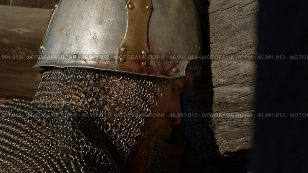 Close up side view of a man in very heavy headdress, middle ages armor concept. Стоковое фото, фотограф David Kashakhi / Фотобанк Лори