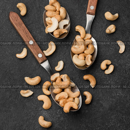 close up spoons filled with healthy raw cashew nuts. High resolution photo. close up spoons filled with healthy raw cashew nuts. High quality photo. Стоковое фото, агентство Ingram Publishing / Фотобанк Лори