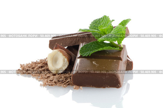 Closeup detail of chocolate parts and mint leaves on white background. Стоковое фото, агентство Ingram Publishing / Фотобанк Лори